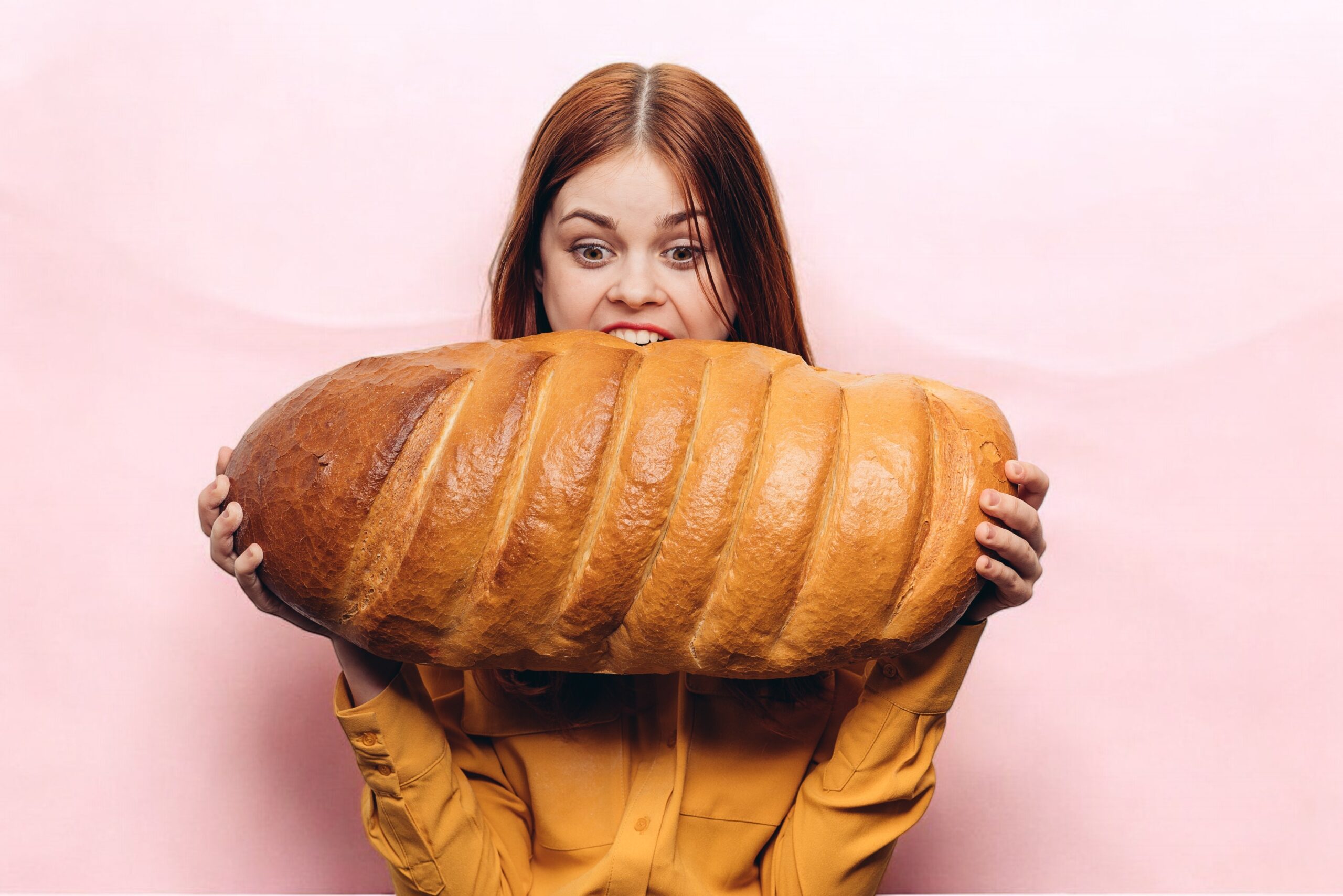 Hungry woman with a huge loaf on a light backgroun 2025 03 10 17 28 54 utc Photoroom